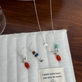 Detail of silver magpie necklace and earring set with colorful gemstone beads - Bird Agate Necklace & Earrings Set