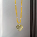 Yellow beaded necklace featuring a large transparent heart-shaped resin pendant charm - Yellow Bead Heart Necklace