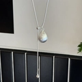 Macro view of adjustable silver water drop pendant on a minimalist snake chain necklace - Brushed Water Drop Style / Silver