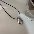 Silver shell-shaped minimalist pendant on black leather cord with modern polished finish - Conch Shell Style
