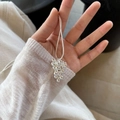 Detail of silver grape cluster pendant necklace on a soft knit sweater background - Silver Grape Cluster Necklace