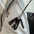 Detail of dark natural stone bead tassels and leather cord on minimalist long necklace - Black Natural Stone