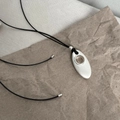 Minimalist long cord necklace with white oval pendant and silver metal accents - Brushed Silver (Black Cord)