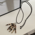 Long beaded tassel necklace with natural striped stones and bohemian earthy style - Dark Zebra Stone