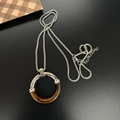 Minimalist stainless steel necklace featuring amber marble textured ring pendant - Silver