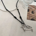 Detail shot of a silver dachshund dog pendant with a minimalist black cord necklace - Black Cord and Polished Finish Dog