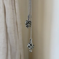 Macro detail of silver necklace featuring spotted natural stone beads in a cluster pendant - Dalmatian Jasper