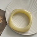 Minimalist light yellow square resin bangle with rounded edges on a spiral tray - Closed (Square) / Egg Yellow Square Bangle