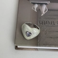 Detailed shot of an adjustable heart ring with marble enamel and inlaid zircon - Cream White Marble Pattern Zirconia Style