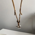 Artistic silver flowing pendant necklace with brown and yellow woven cord detail - Adjustable Brown Black Cord with Kettle Handle Pendant
