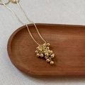 Elegant gold necklace featuring a grape cluster pendant of polished beads on a snake chain - Gold Grape Cluster