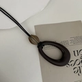 Long brown amber resin pendant necklace with minimalist tassel and black cord - Beige Long Oval Pendant (5)