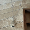 Detailed close-up of oval silver pendant necklace with OT toggle clasp on stone surface - OT Buckle / Silver