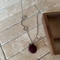 Detail of silver chain necklace featuring burgundy bottle pendant and OT toggle clasp - OT Buckle / Red