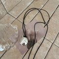 Detailed view of silver oval pendant with mirror finish and adjustable black leather cord - Black Rope / Bright Silver