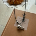 Silver whale pendant with black woven cord necklace and tassel charm on warm backdrop - Bright Silver Fish with Black Cord