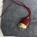 Elegant burgundy leather and gold metal pinecone pendant necklace on a textured grey background - Burgundy Leather With Gold Metal / Burgundy Leather Pinecone Necklace