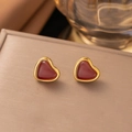 Minimalist gold-plated heart stud earrings with natural red agate stones on display - Stud Earrings / Red Heart Stud Earrings