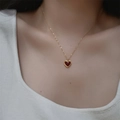 Minimalist gold necklace with red heart-shaped agate pendant worn by female model - Gold-Red Heart