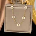 Detail of gold chain necklace with five white pearl flower pendants on display - Five Pearl Flower Necklace / Gold