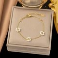 Detail view of a gold pearl flower bracelet with lobster clasp on a luxury jewelry box - Three Pearl Flower Bracelet / Gold