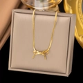Detailed view of a gold bow pendant necklace with a sleek snake chain on a jewelry box - [XLH605] Bow Necklace Gold