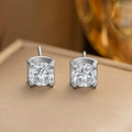 Macro shot of silver six-claw diamond earrings with sparkling round cut stones - Single Diamond Stud Earrings / Silver