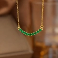 Elegant gold necklace with curved pendant featuring eleven vibrant green gemstones - Gold Green Zirconia