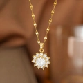 Macro shot of gold sun flower pendant necklace with central gemstone and pavé diamonds - White Zirconia Sunflower (9141) / Gold
