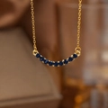 Elegant 18K gold smile necklace with curved dark blue gemstones in minimalist style - Gold Blue Zirconia