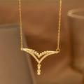 Macro shot of gold V-shaped necklace pendant with shimmering zircon and small round drop - Double Layer V Style (9158)