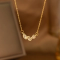 Macro view of gold necklace with three water-drop gemstones and delicate chain - Three Water Drop Diamonds (9172)