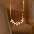 Macro view of gold necklace with curved heart-shaped zirconia stones and wheat ear pendant - Seven Hearts Array (9174)