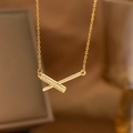 Close-up of minimalist gold-plated cross pendant necklace with sparkling zircon pavé - X-Cross Geometric Style (9181)