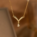 Detail of gold V-shaped necklace with a sparkling teardrop diamond pendant and fine chain - V-Curve Water Drop Dangle (9184)