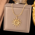 Close-up of golden sun pendant with spiral texture on snake chain with gold beads - Sun Necklace (H1242) / Gold