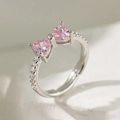 Macro detail of silver ring with pink heart-shaped zircons in a butterfly design - Pink Zircon Bowknot Style (F1198) / Silver