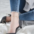 Elegant gold titanium steel anklet with polished beads on a woman wearing high heels - Anklet / Rose Gold