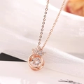 Rose gold crown necklace with dancing cubic zirconia on elegant white fabric - Dancing Round Crown Necklace / Rose Gold