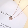 Macro shot of 14K rose gold heart pendant with pavé set cubic zirconia on stylish chain - Rose Gold