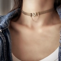 Detail of gold woven mesh choker featuring a M letter pendant and delicate tassel chain - Necklace / Gold