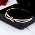 Rose gold interlocking knot bracelet with pavé cubic zirconia in a jewelry box - Lucky Knot Intertwined Style / Rose Gold