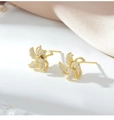 Golden rotating windmill earrings set with sparkling white crystals on silk background - 925 Silver Earring Post / Gold Earrings