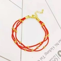 Detail of red braided cord bracelet with gold beads, lobster clasp and extension chain - Round Beads Triple Layer Style