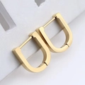 Close-up of golden U-shaped geometric earrings with a minimalist metallic finish - U-Shape Style