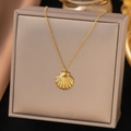 Elegant gold titanium steel necklace featuring a textured seashell fan pendant - Dainty Shell Necklace (H340)