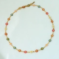 Detailed macro view of S-STEEL hallmark on golden 18k plated daisy chain necklace - Multicolor Necklace