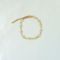 Detail of 18k gold daisy chain bracelet with white enamel flowers and lobster clasp - White Bracelet