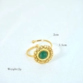 Detailed macro view of bohemian gold open ring with green natural stone and chain texture - Green Gemstone / African Jade