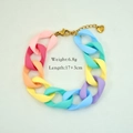 Macro detail of colorful matte acrylic links and gold heart charm on a steel bracelet - Mixed Color 1